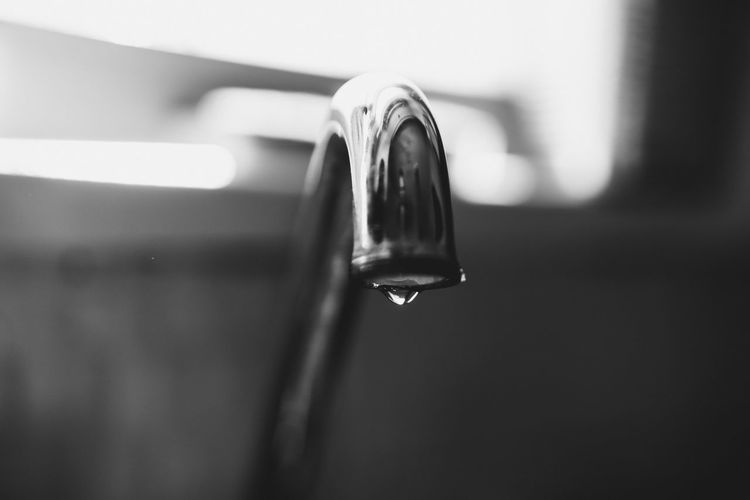 Close-up of water faucet in container