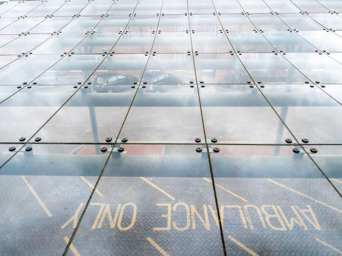 High angle view of text on glass floor