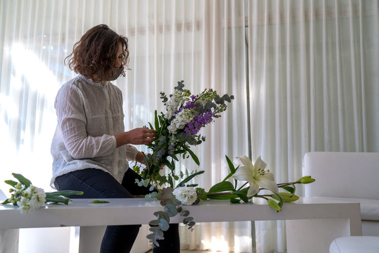 Woman holding flowers at home