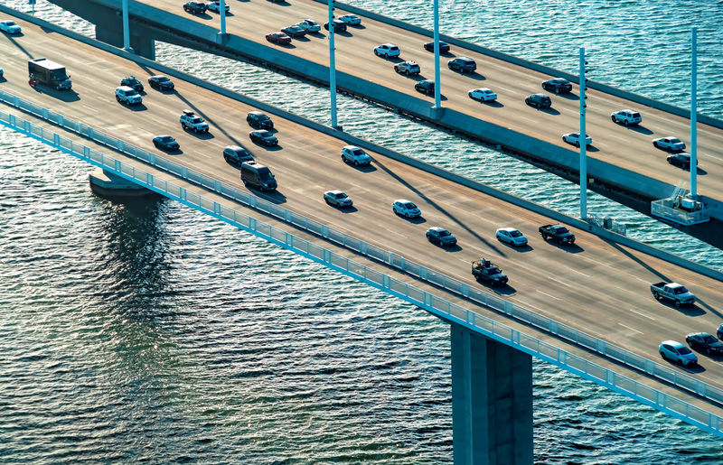 High angle view of vehicles moving on bridge over sea