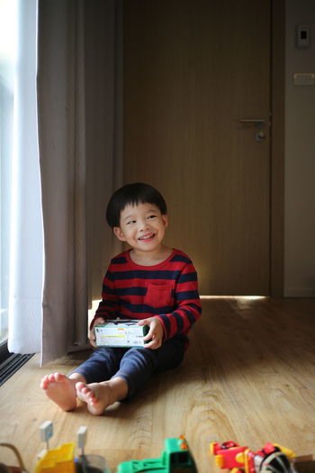 Smiling boy sitting at home