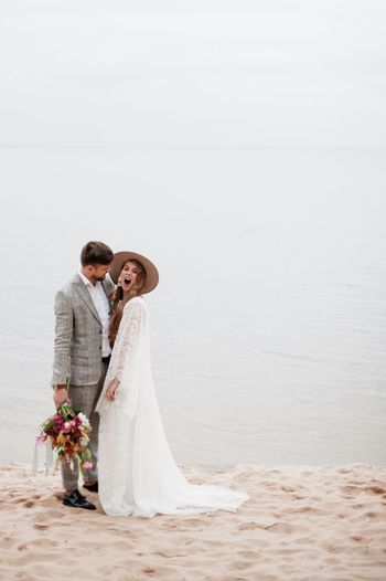 Bride and bridegroom standing at beach during wedding ceremony