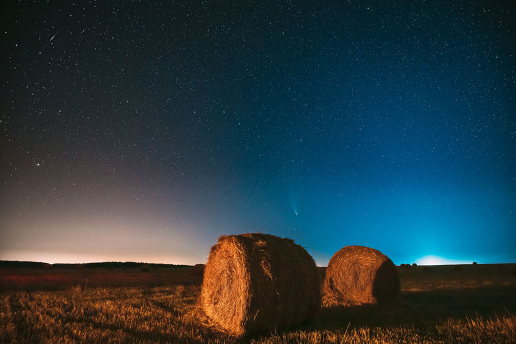 Scenic view of landscape against sky at night