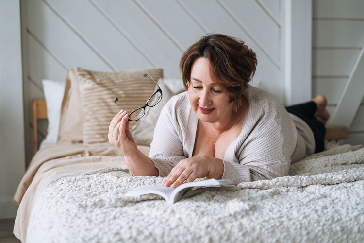 Portrait of young woman sleeping on bed at home