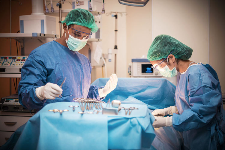 Surgeons performing operation on patient at hospital