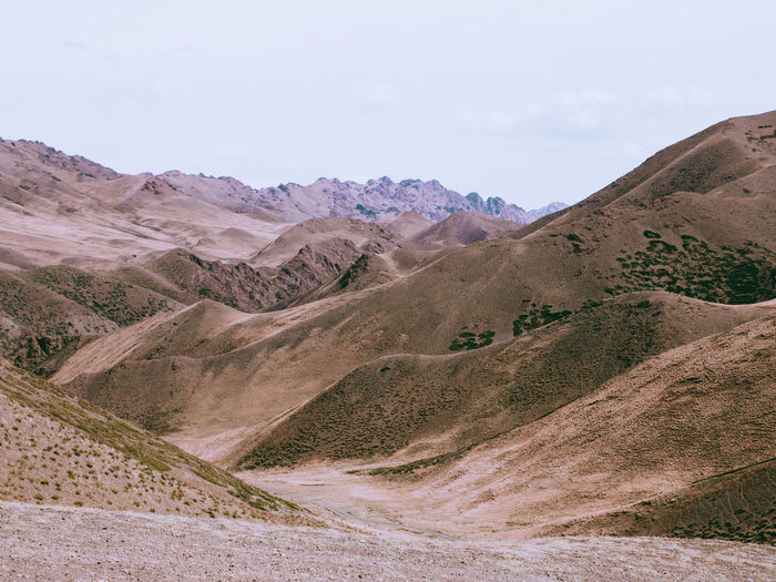 Scenic view of arid landscape against sky