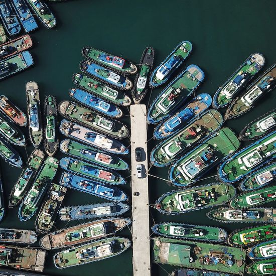 Aerial view of ships moored at harbor
