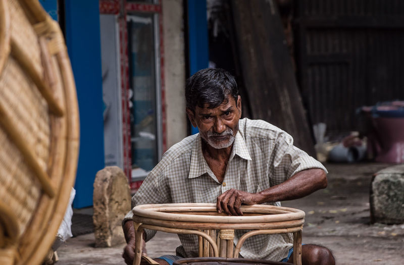 Portrait of man making wooden furniture