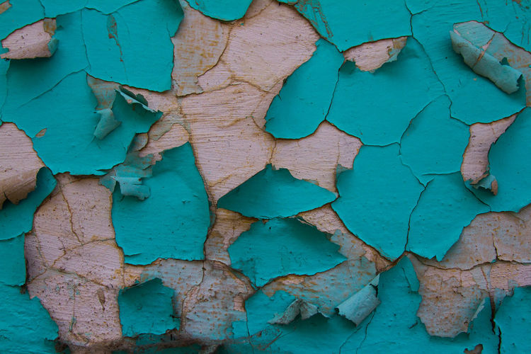 Full frame shot of weathered peeled blue wall