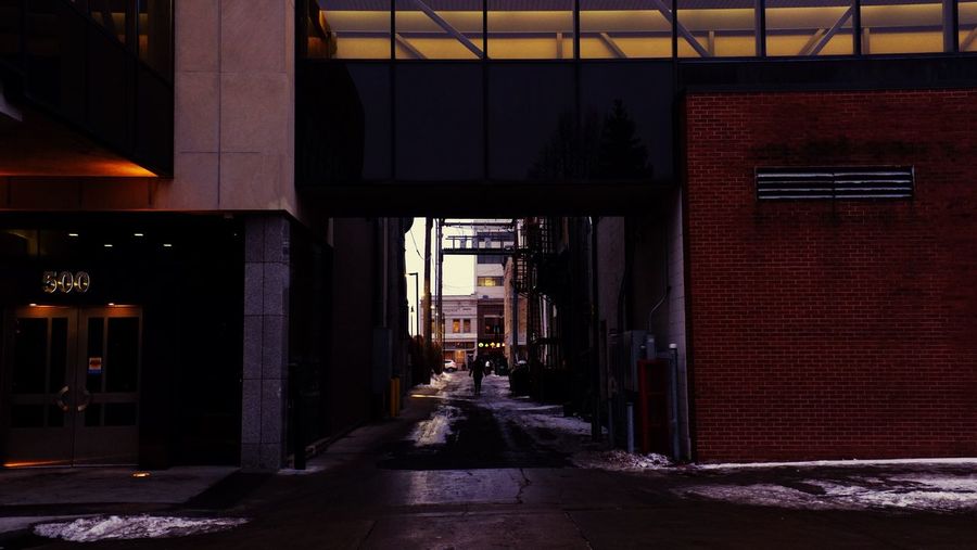 Alley amidst buildings during winter