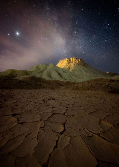 Scenic view of desert against sky at night
