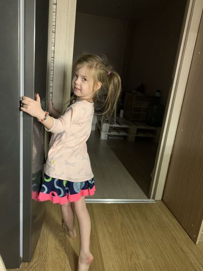 Full length of cute girl standing at home