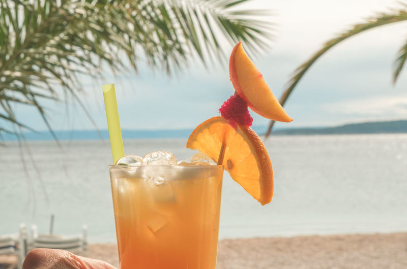 Close-up of planter's punch cocktail on beach