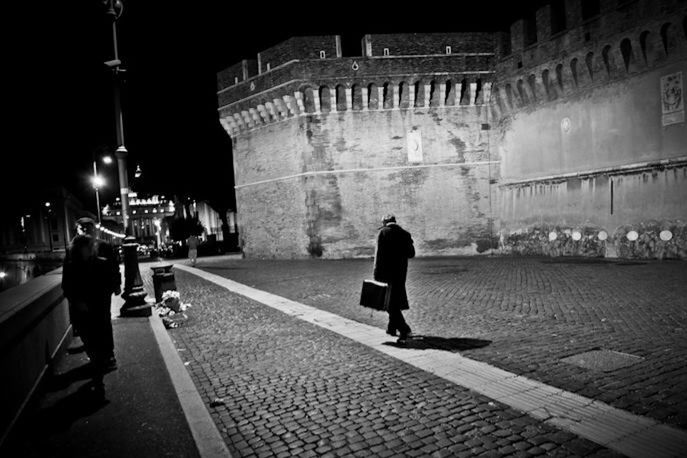 Rear view of woman walking in city at night
