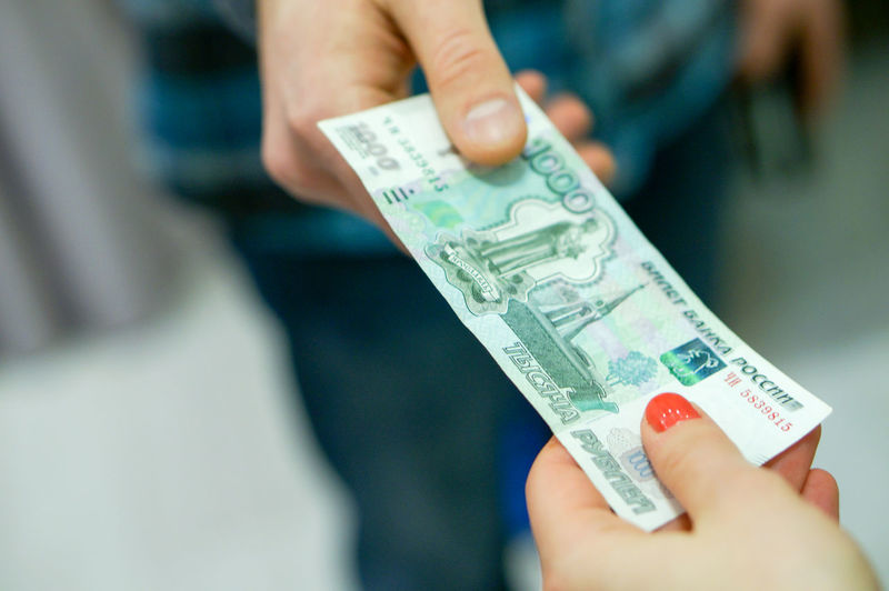 Close-up of hands holding paper currency indoors