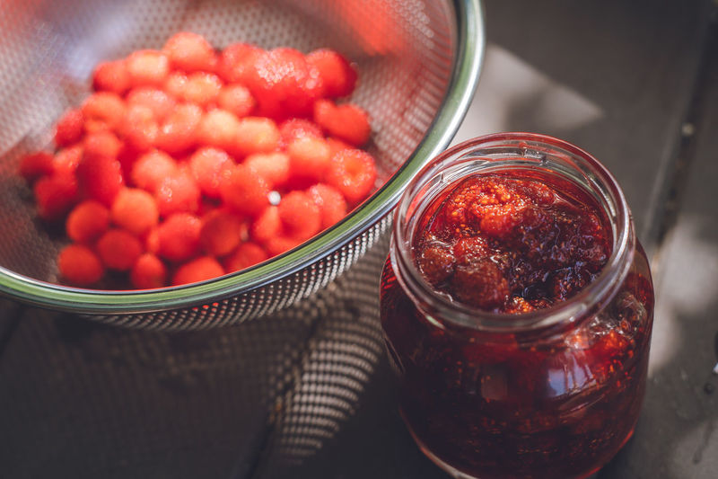 Making homemade jam from picked wild strawberries