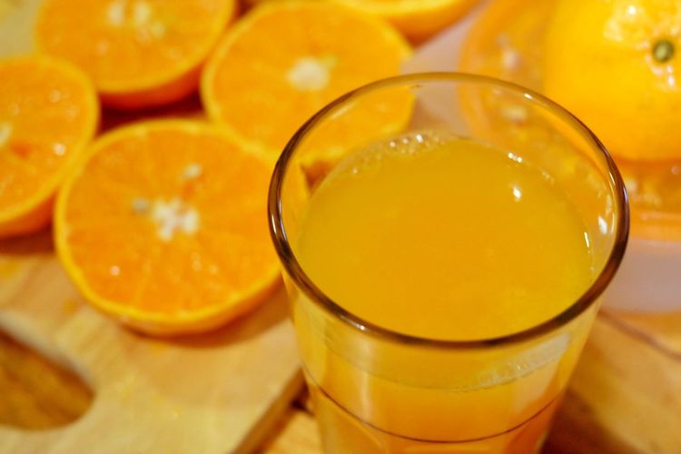 Close-up of orange juice in glass on table