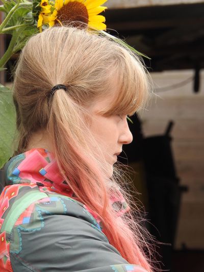 Side view of young woman with dyed brown hair