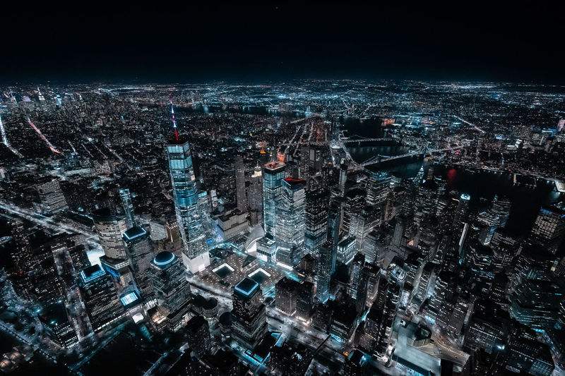 Aerial view of illuminated city buildings at night