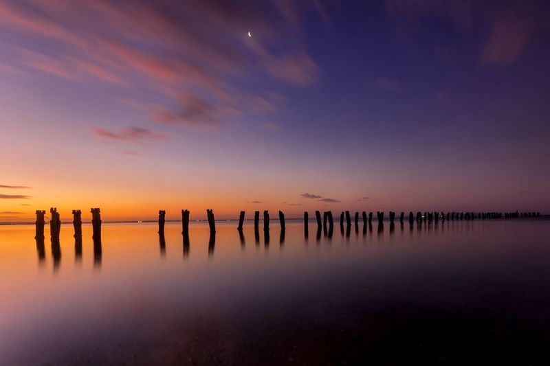 Scenic view of calm sea at sunset