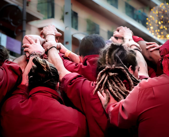 Rear view of sports team huddling