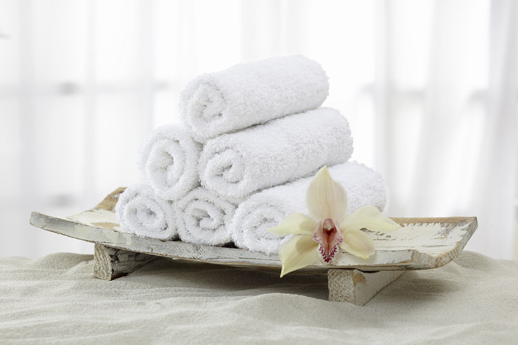 Towels, towel rolls on sand