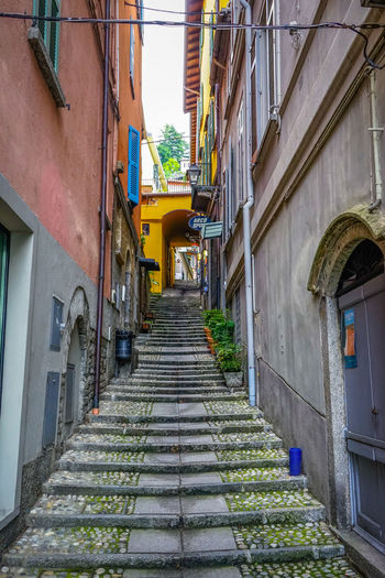 Low angle view of steps amidst buildings