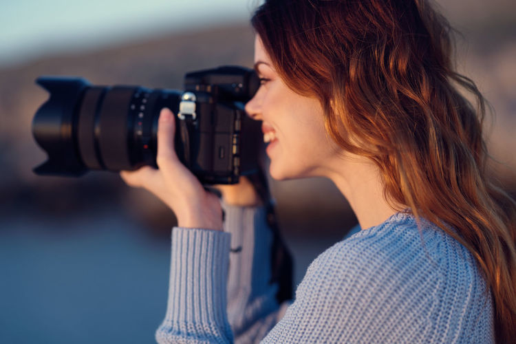 Portrait of woman photographing