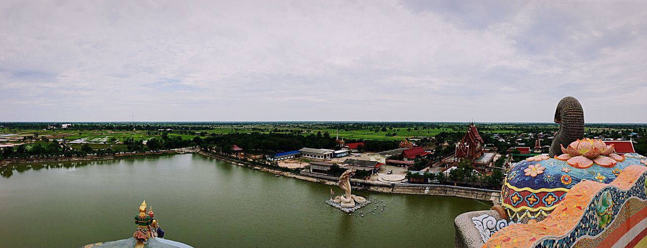 High angle view of wat ban rai by river against cloudy sky