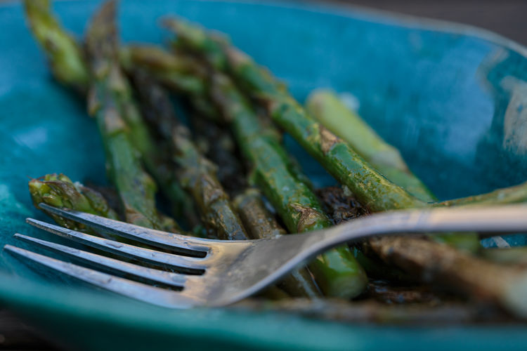Close up of asparagus in a turquoise bowl