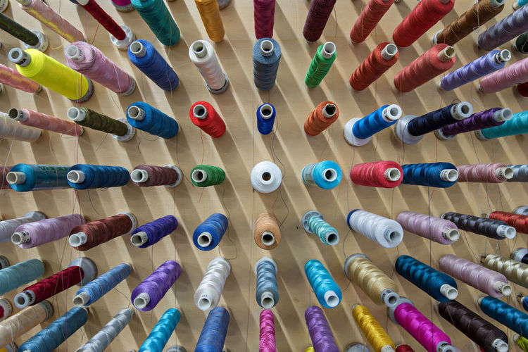 Full frame shot of colorful thread spools on table