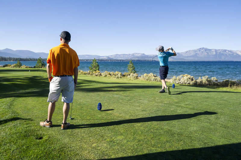 Two men playing golf at edgewood tahoe in stateline, nevada.