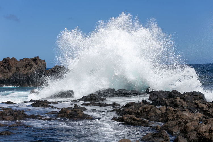 Sea waves splashing on rocks