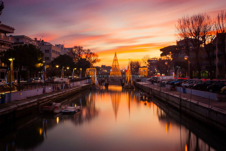 View of river in city at sunset