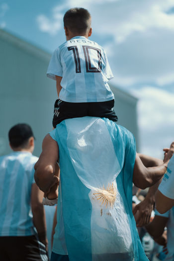Father and son with argentinan flags celebrating victory fifa worldcup champions 2022