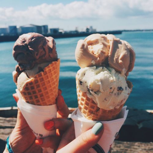Close-up of hands holding ice cream cones