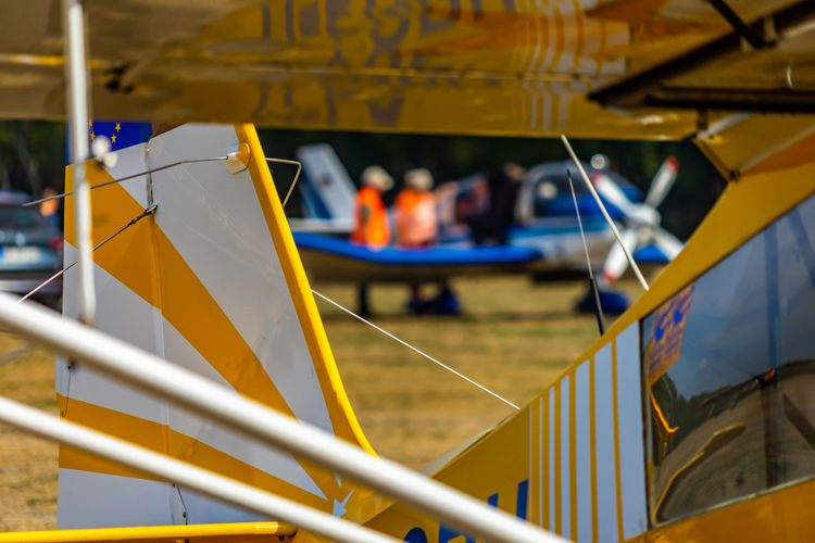 Abstract looking picture of the rear part of a yellow and white striped antique small plane.