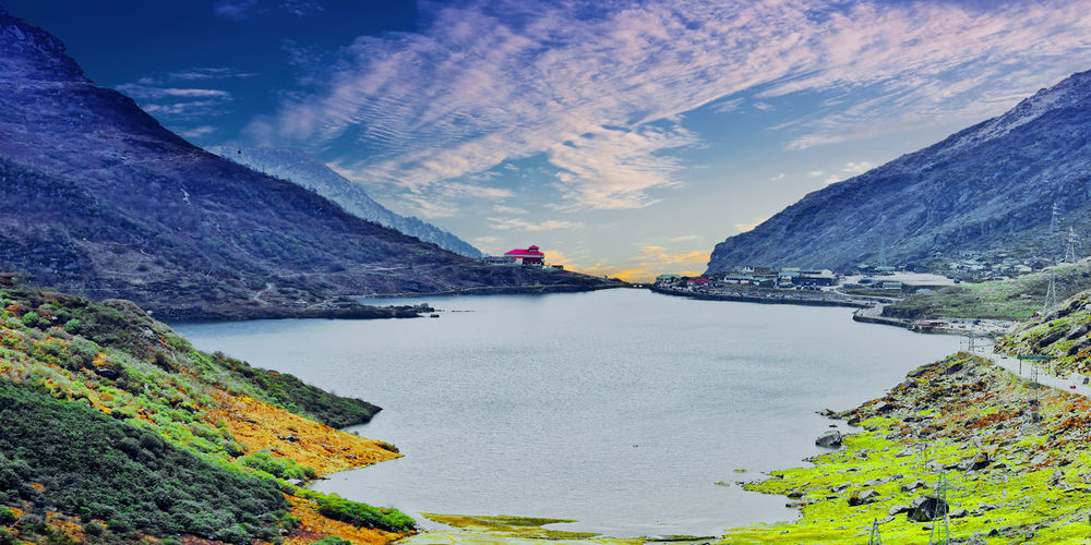 Scenic view of lake and mountains against sky