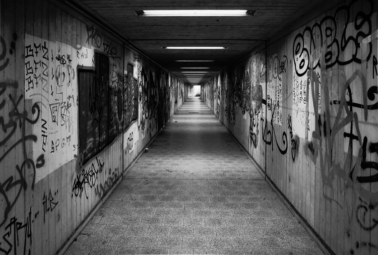 Graffiti on wall of empty tunnel