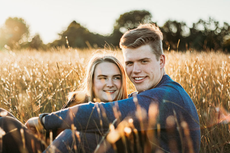 Portrait of a smiling young couple on field