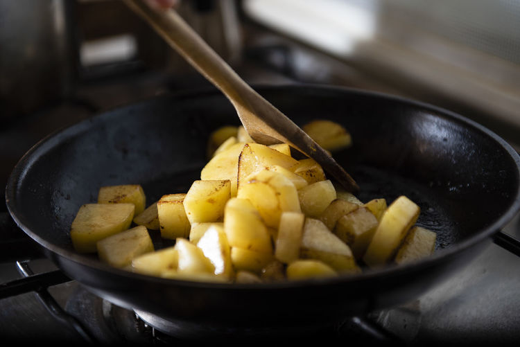Woman cooking a vegetable soup with pumpkin, potato and onion. s
