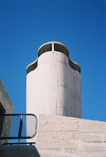 Low angle view of water tank against clear blue sky