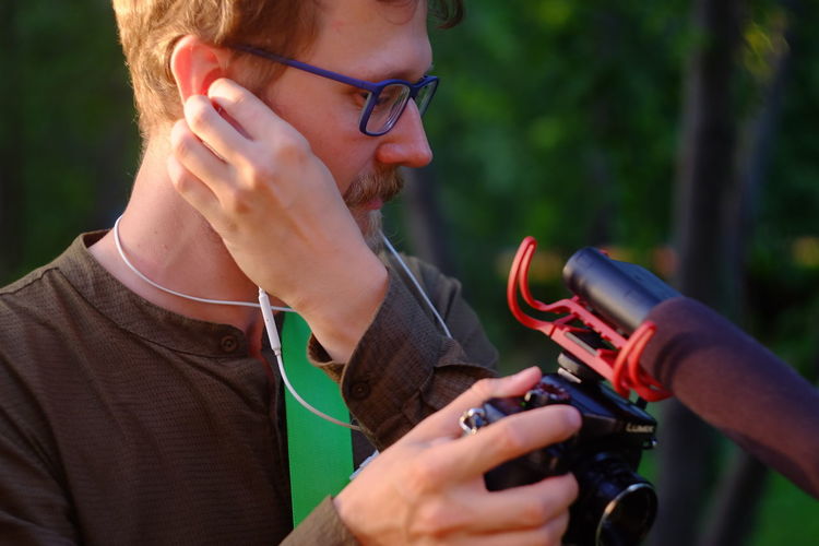 Low section of man holding camera