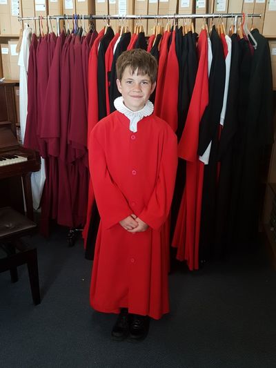 A boy chorister poses on his first day. 