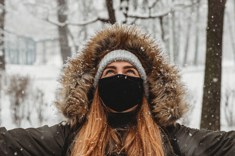 Portrait of young woman covered with snow