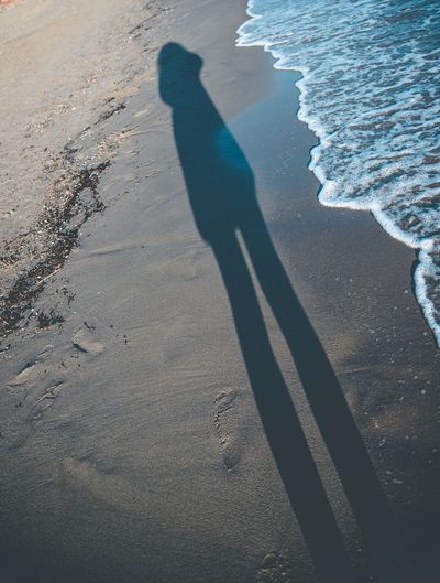 Shadow of person on beach