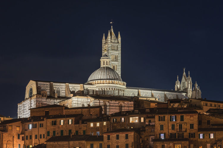 Night view of the cathedral of siena above the historic centre of siena, tuscany, italy