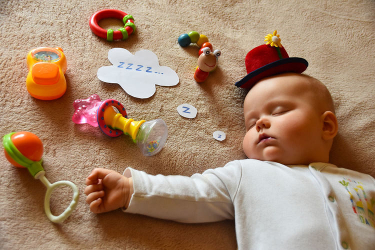 Cute baby boy with toy toys
