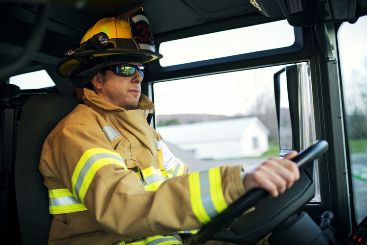 Confident firefighter driving fire engine