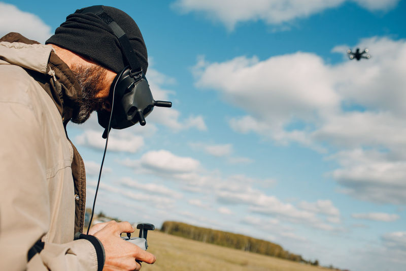 Man photographing umbrella against sky